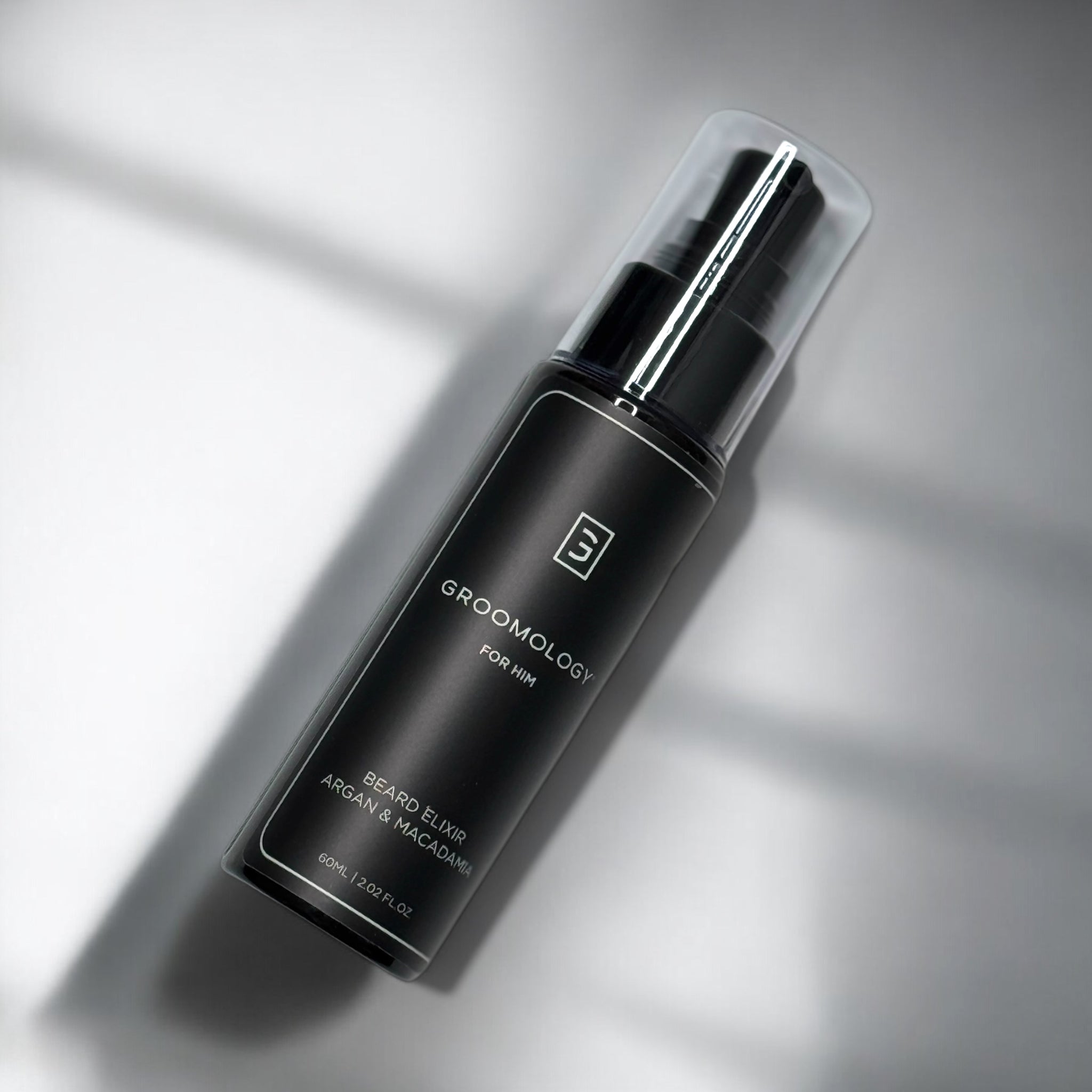 GROOMOLOGY® Argan & Macadamia Elixir in a sleek black bottle for premium beard care and nourishment.